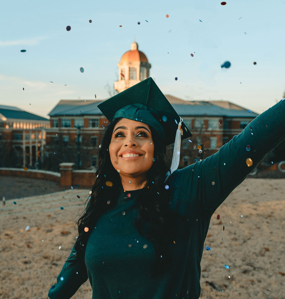 Student wearing a graduation cap and smiling